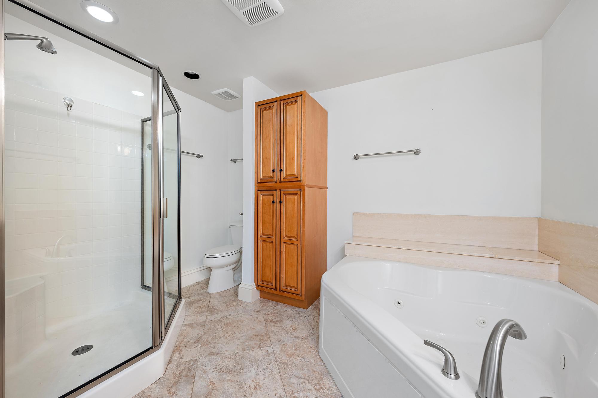 1504 Captains Way Jupiter, FL 33477 - Photo 23 of 51 a bathroom with a tub shower and sink
