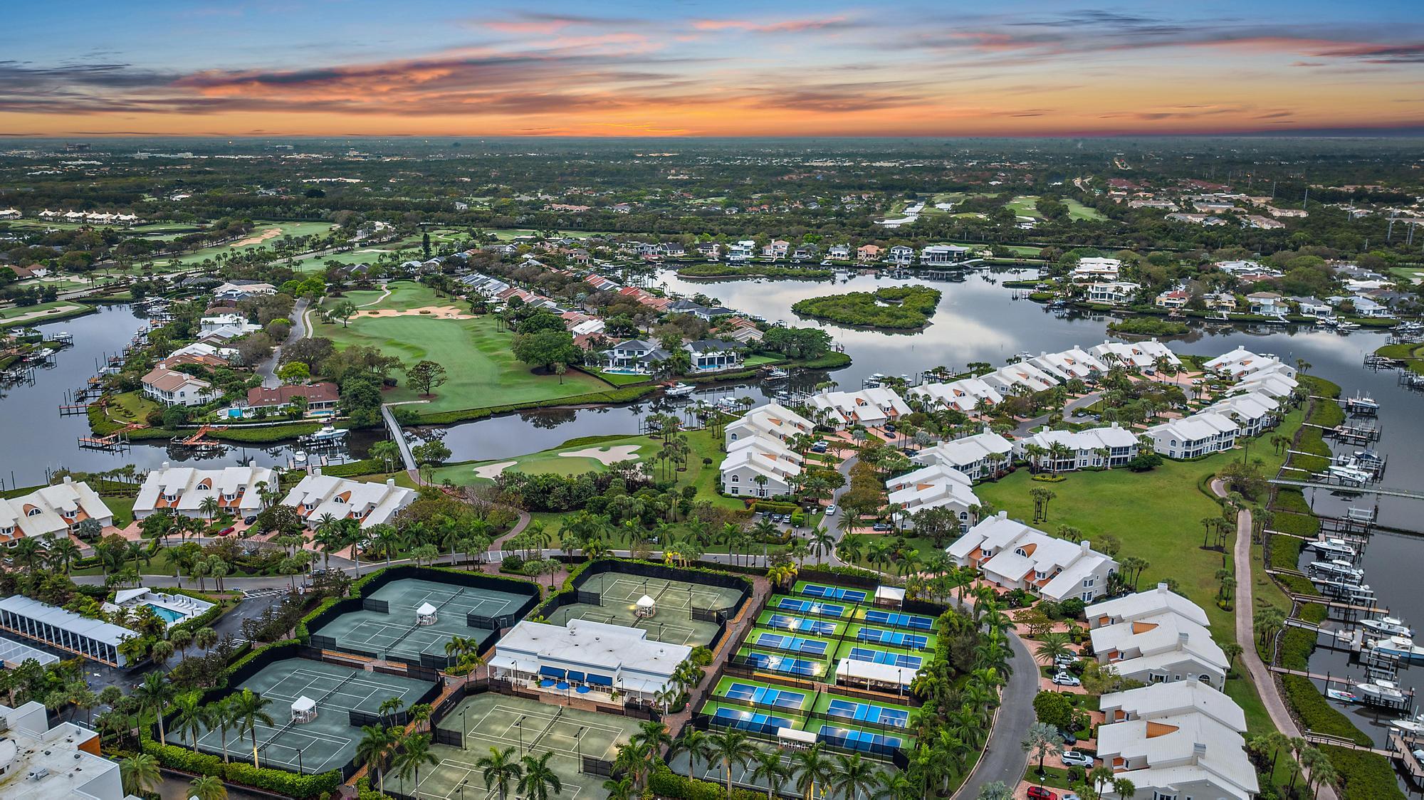 1504 Captains Way Jupiter, FL 33477 - Photo 30 of 51 an aerial view of a city with lots of residential buildings ocean and mountain view in back