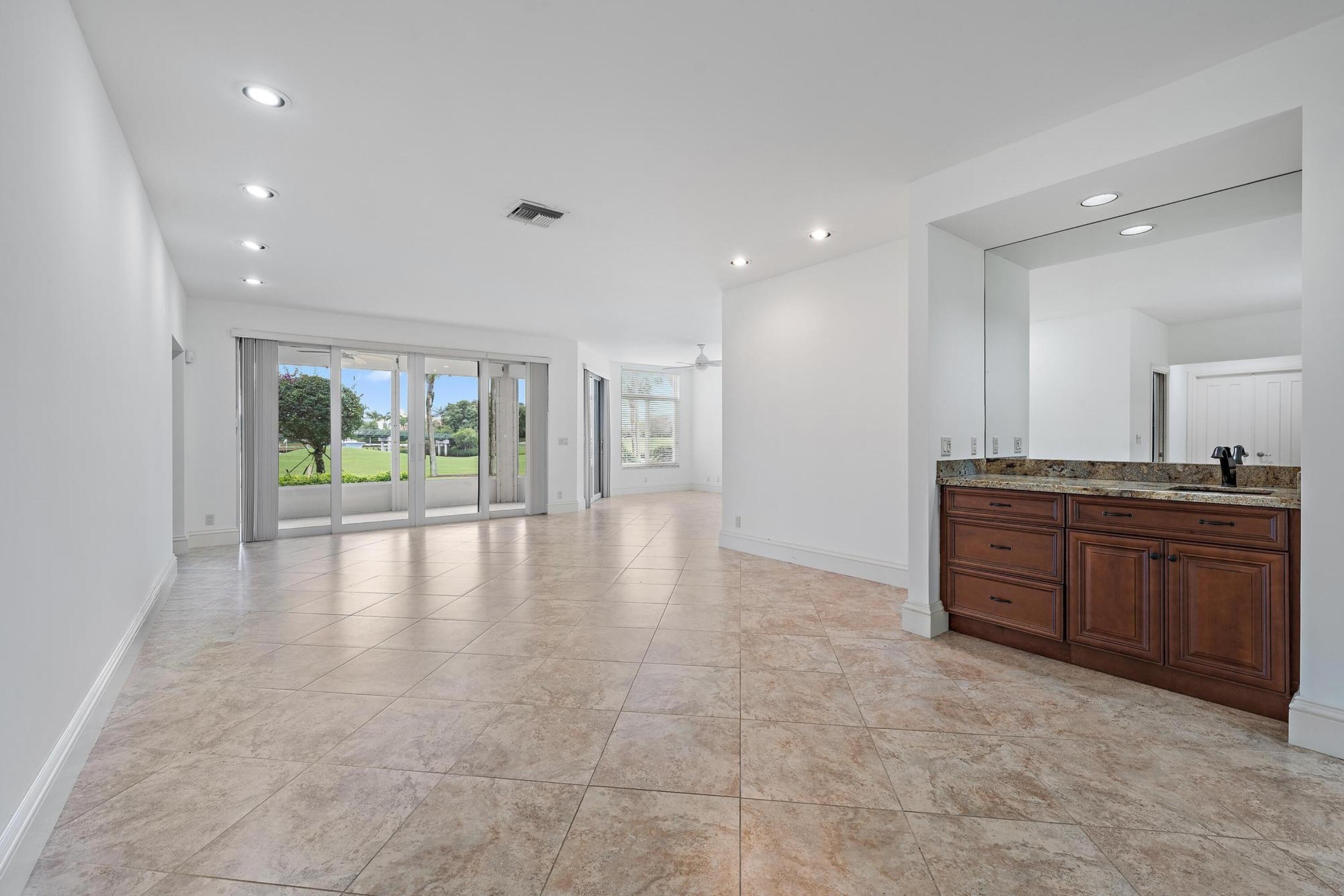 1504 Captains Way Jupiter, FL 33477 - Photo 4 of 51 a view of an empty room with a stove and large window