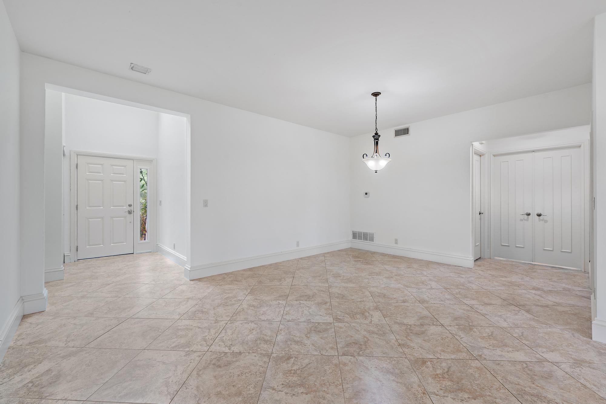 1504 Captains Way Jupiter, FL 33477 - Photo 5 of 51 an empty room with fan and entrance