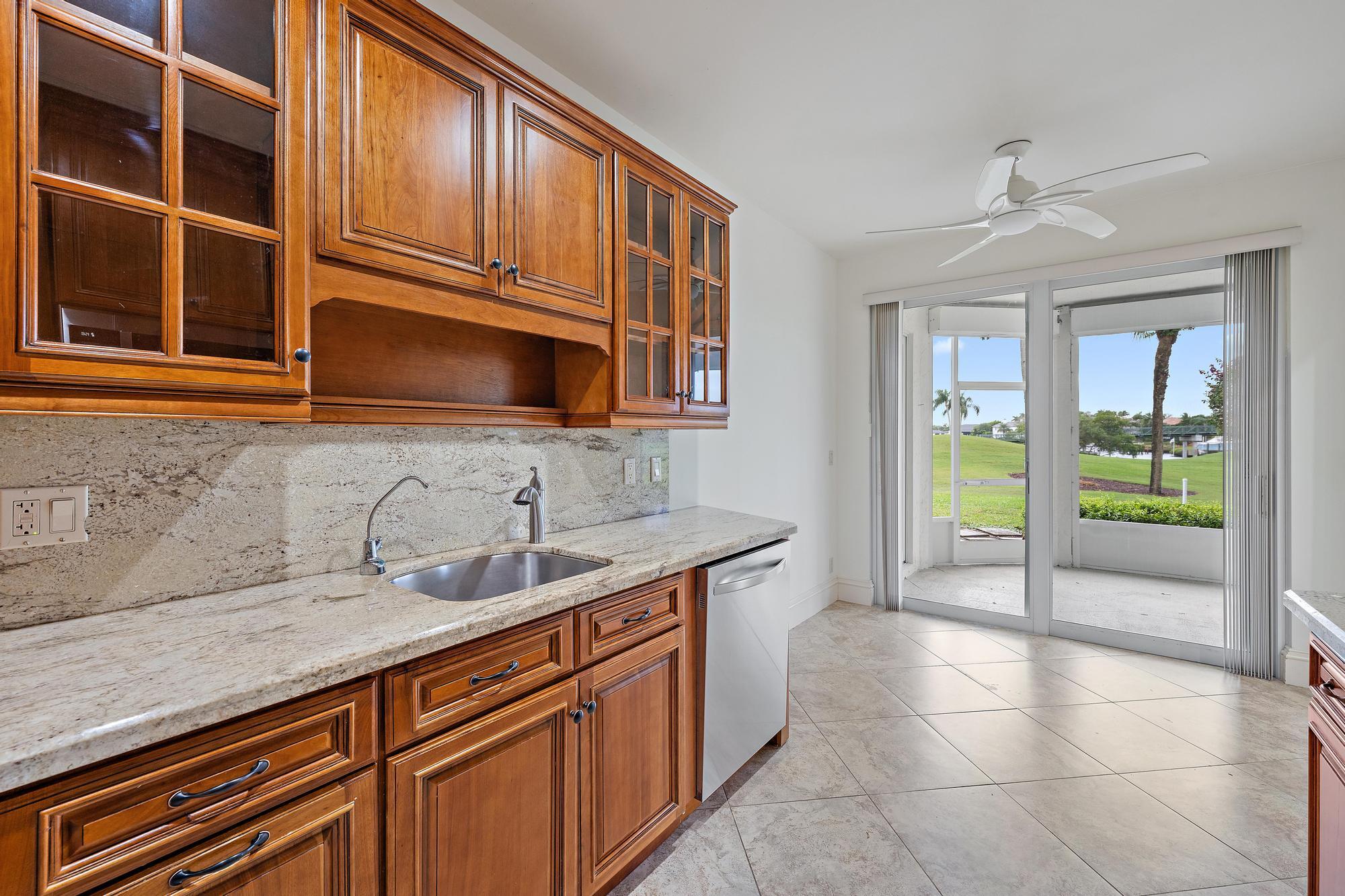 1504 Captains Way Jupiter, FL 33477 - Photo 7 of 51 a kitchen with a sink and a microwave