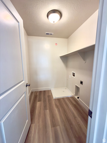 1823 South Longview Road Santaquin, UT 84655 - Photo 43 of 69 Utility room featuring wood-finish flooring, white baseboards, and a built-in wall shelf