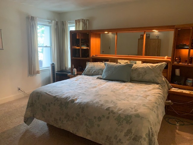 703 North 12th Street Rochelle, IL 61068 - Photo 22 of 37 a bed sitting in a bedroom next to a window