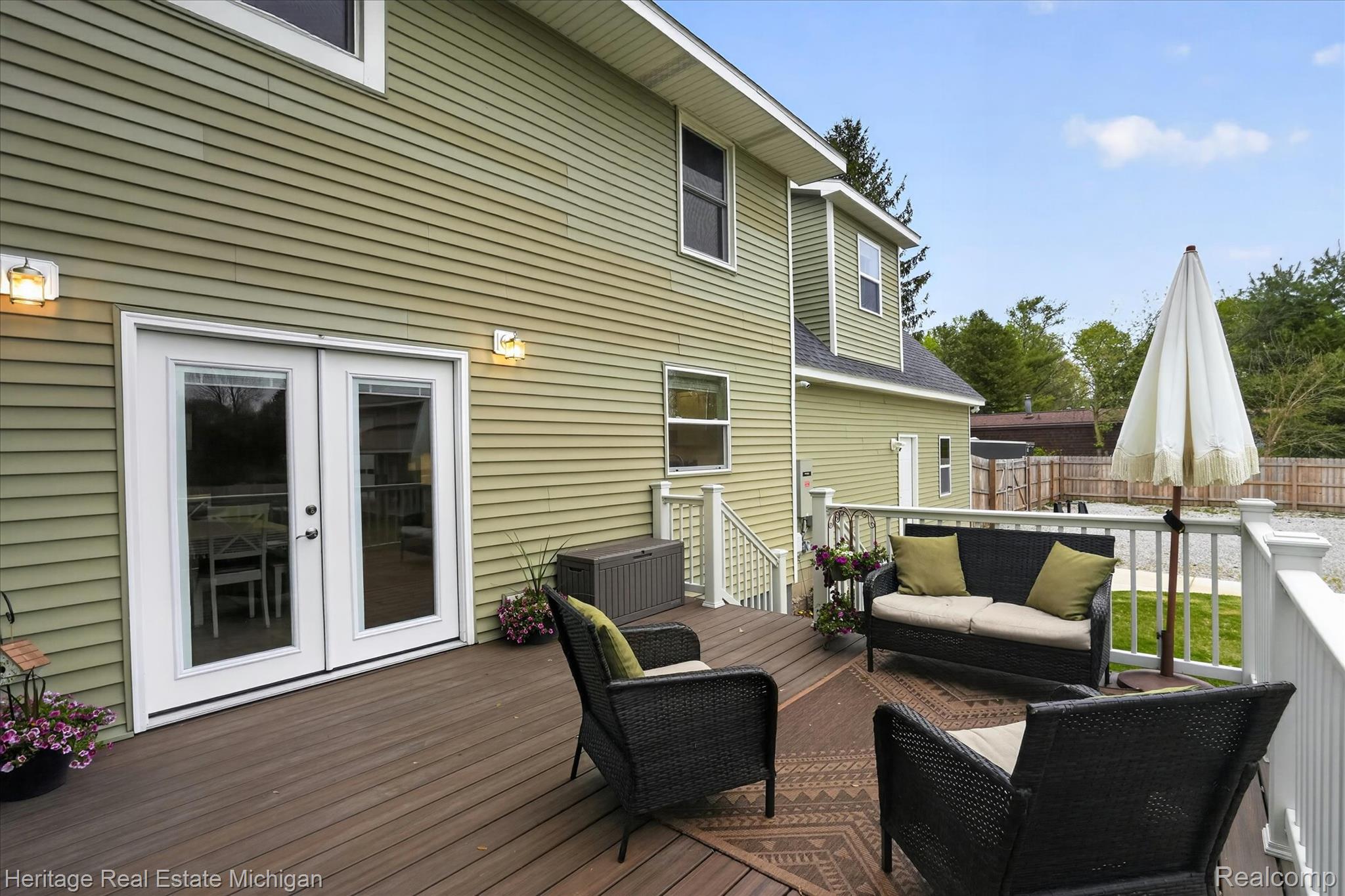 5835 Warner Road Fowlerville, MI 48836 - Photo 39 of 59 Wooden deck with french doors and outdoor seating
