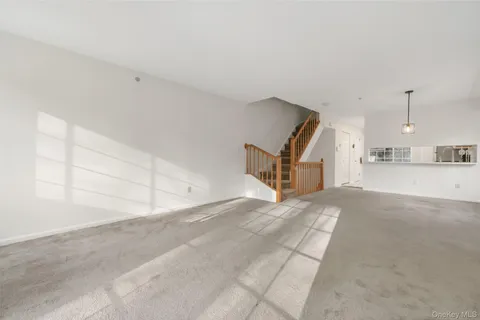 a view of a livingroom with furniture and a kitchen