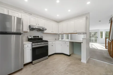 a kitchen with stainless steel appliances a refrigerator sink and cabinets