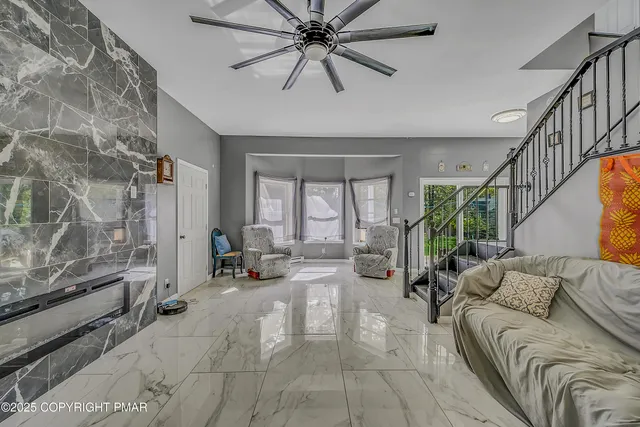 a living room with furniture and a large window