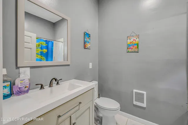 a bathroom with a sink mirror vanity and toilet