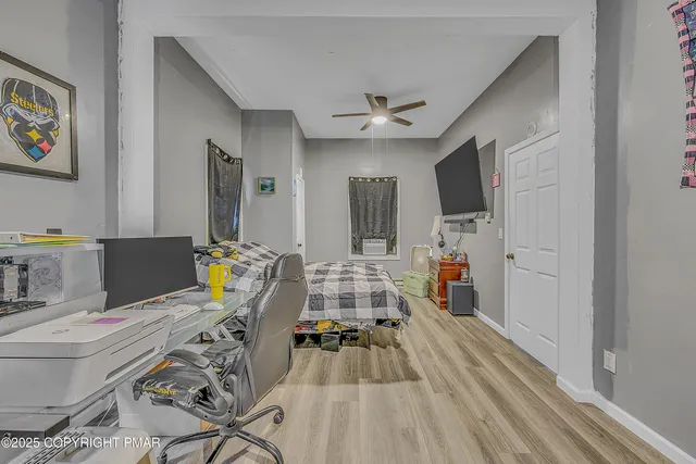 an empty room with wooden floor and a window