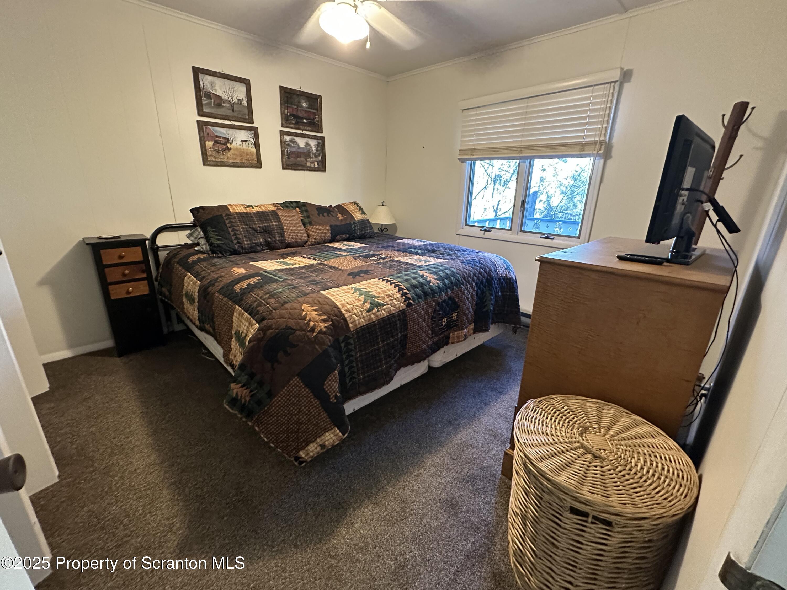 25 Fall Place Union Dale, PA 18470 - Photo 17 of 27 a bedroom with a bed and wooden floor