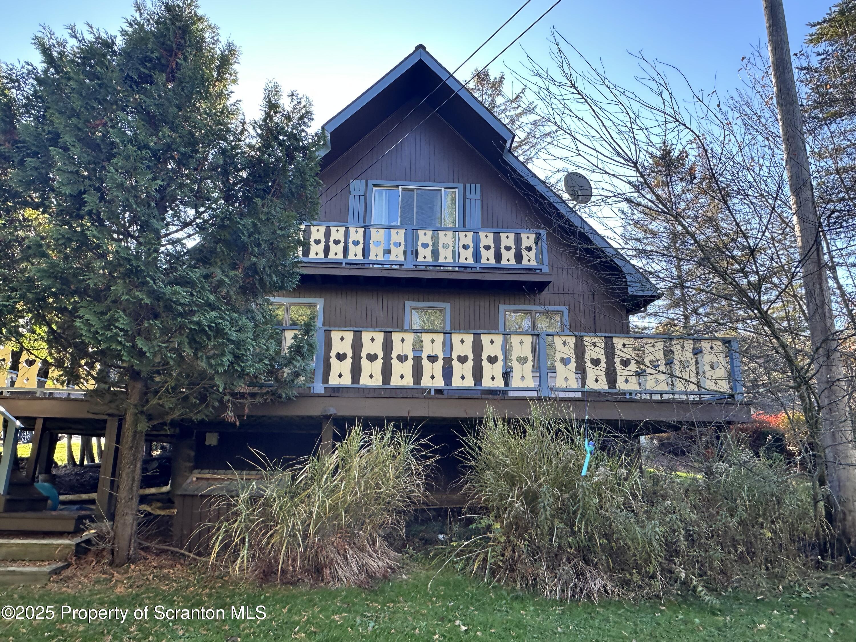 25 Fall Place Union Dale, PA 18470 - Photo 25 of 27 a view of a house with wooden deck and a yard