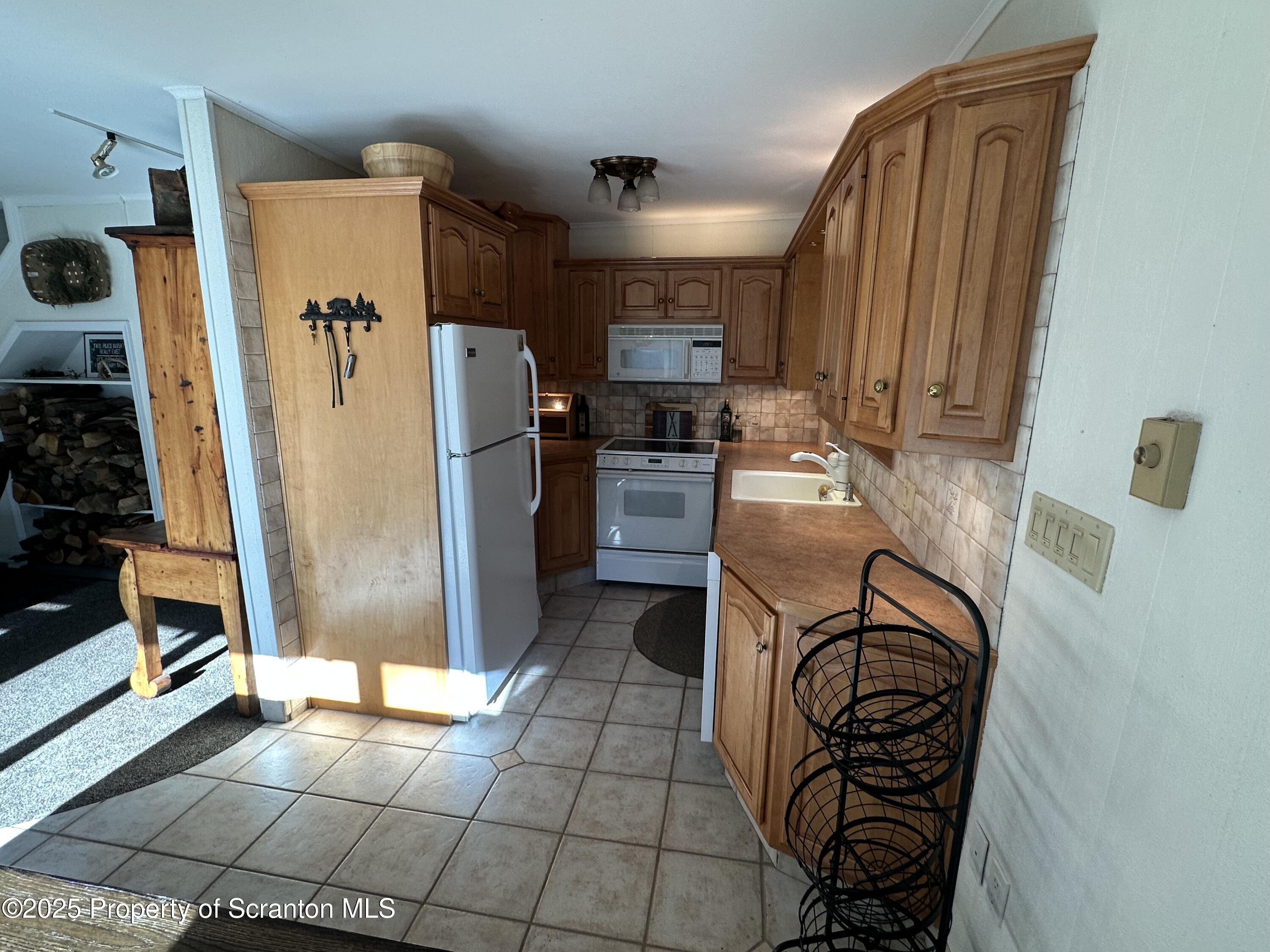 25 Fall Place Union Dale, PA 18470 - Photo 9 of 27 a kitchen with stainless steel appliances granite countertop a refrigerator and a stove