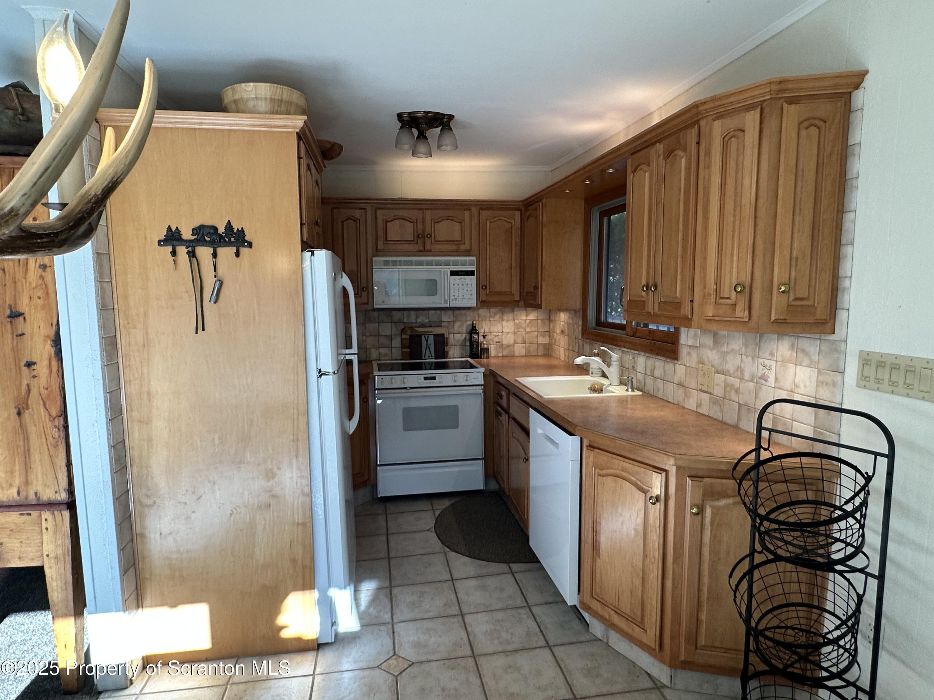 25 Fall Place Union Dale, PA 18470 - Photo 10 of 27 a kitchen with stainless steel appliances granite countertop a refrigerator and a stove