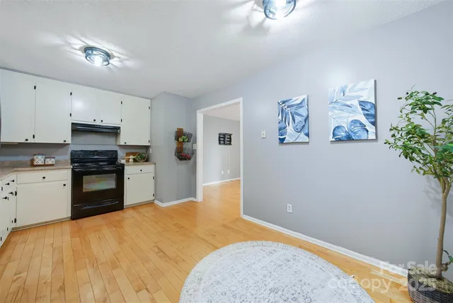 a kitchen with a refrigerator and a stove top oven