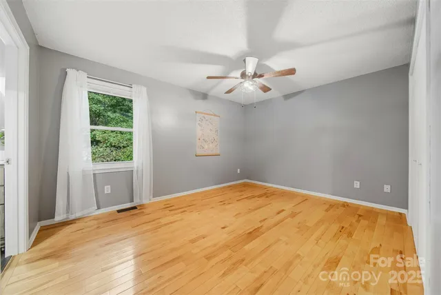 a view of a bedroom with a large bed and a window