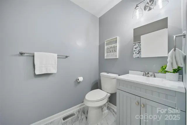 a bathroom with a sink a toilet and mirror