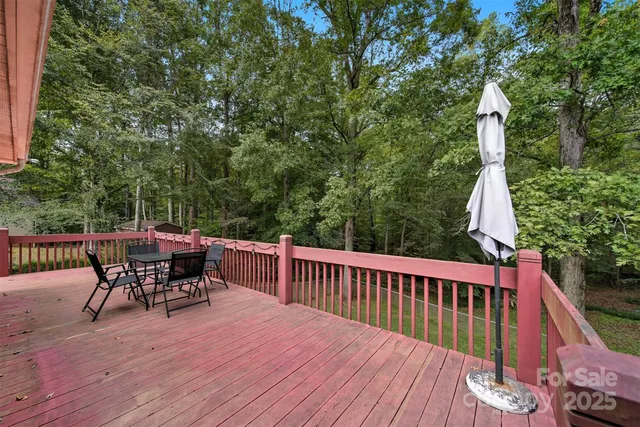 a view of a roof deck with table and chairs and wooden floor