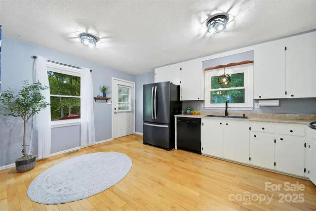 a kitchen with stainless steel appliances a refrigerator sink and cabinets