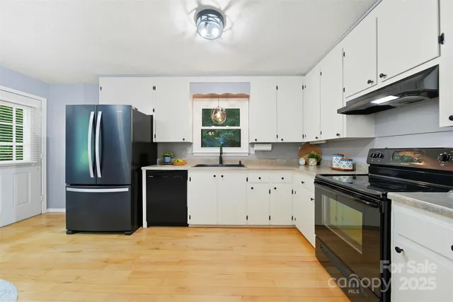a kitchen with stainless steel appliances granite countertop a refrigerator stove and sink