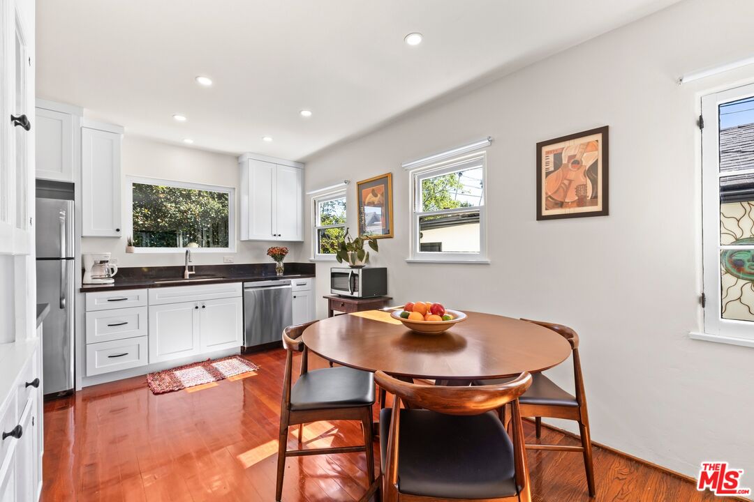 910 North Bushnell Avenue Alhambra, CA 91801 - Photo 15 of 23 a kitchen with stainless steel appliances kitchen island granite countertop a dining table chairs and window