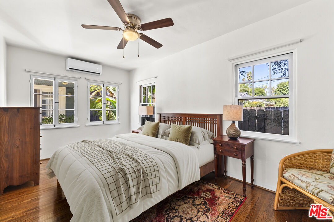 910 North Bushnell Avenue Alhambra, CA 91801 - Photo 17 of 23 a bedroom with a bed a window and a chandelier