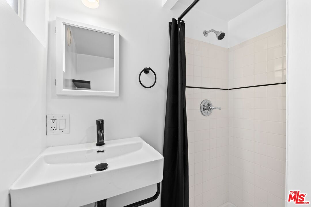 910 North Bushnell Avenue Alhambra, CA 91801 - Photo 21 of 23 a bathroom with a sink and mirror