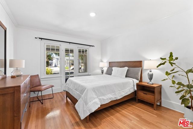 a spacious bedroom with a bed and a couch