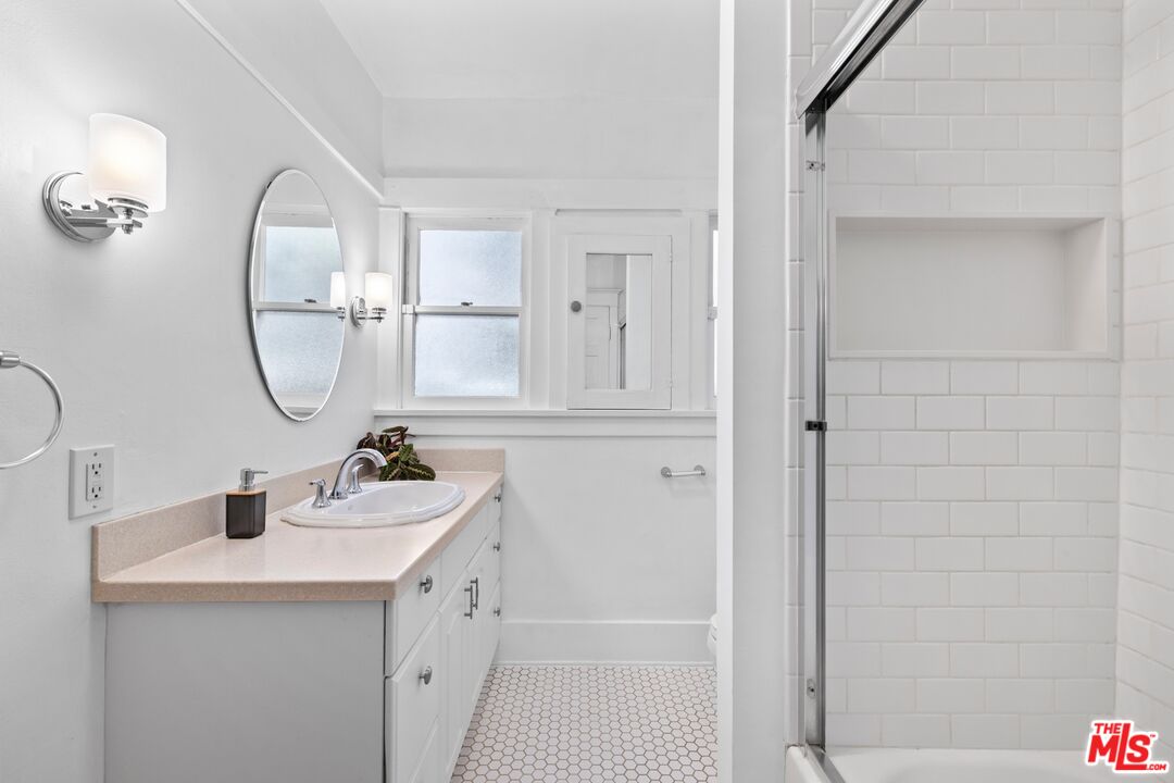 910 North Bushnell Avenue Alhambra, CA 91801 - Photo 8 of 23 a bathroom with a sink a mirror and vanity