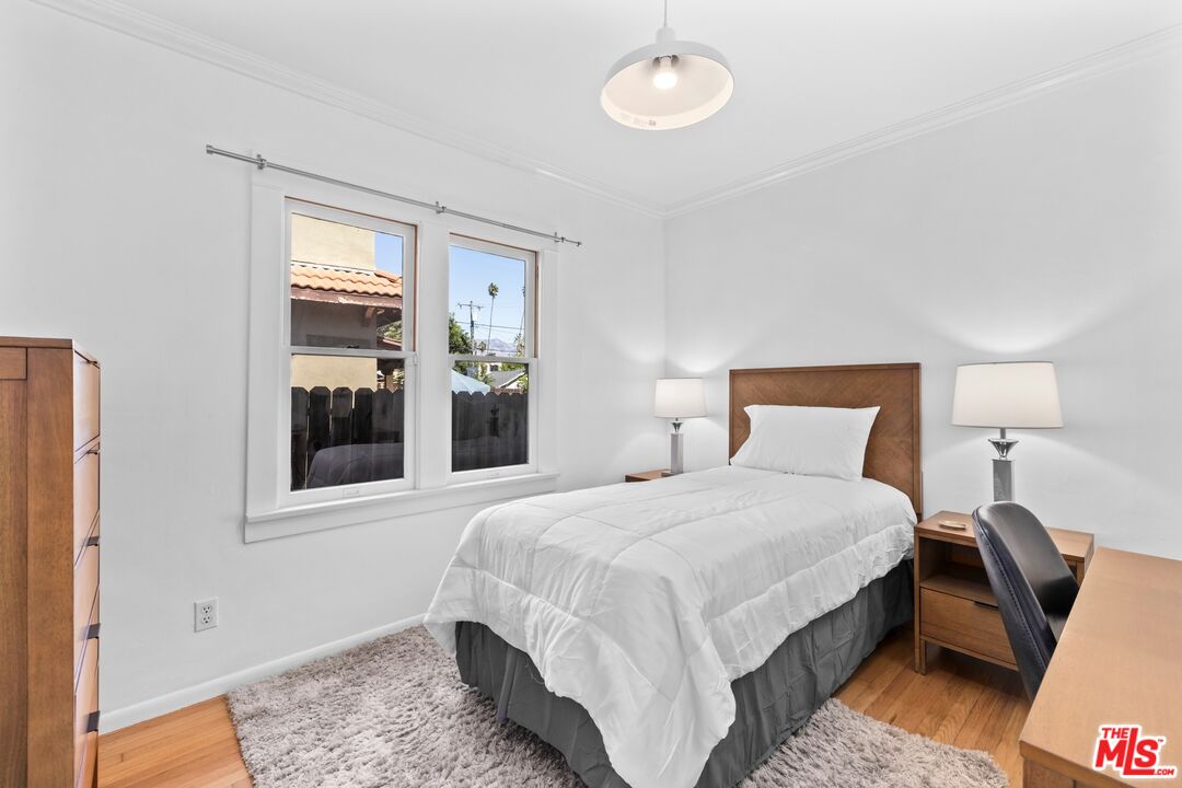 910 North Bushnell Avenue Alhambra, CA 91801 - Photo 9 of 23 a bedroom with a bed and a window
