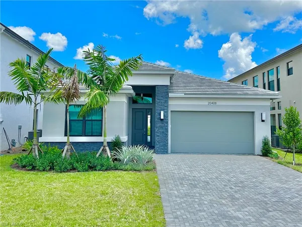 a front view of a house with a yard and garage