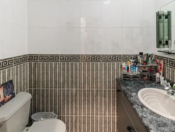 a bathroom with a sink toilet and mirror