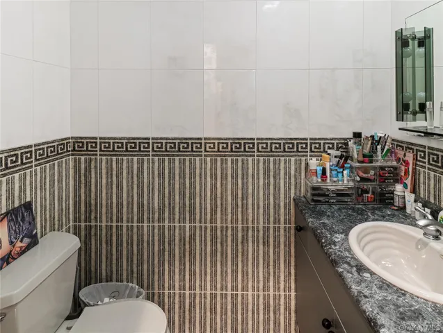 a bathroom with a sink toilet and mirror