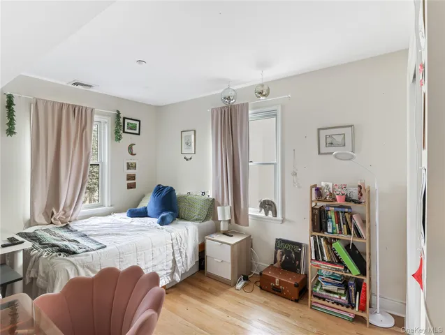 a bedroom with a bed and a book shelf