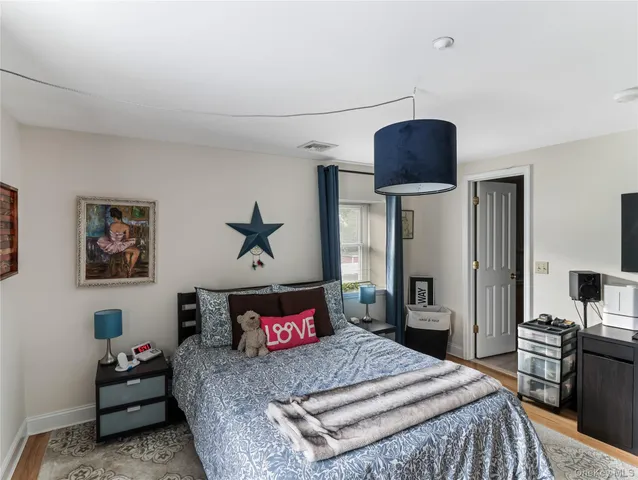 a bedroom with a bed and dresser