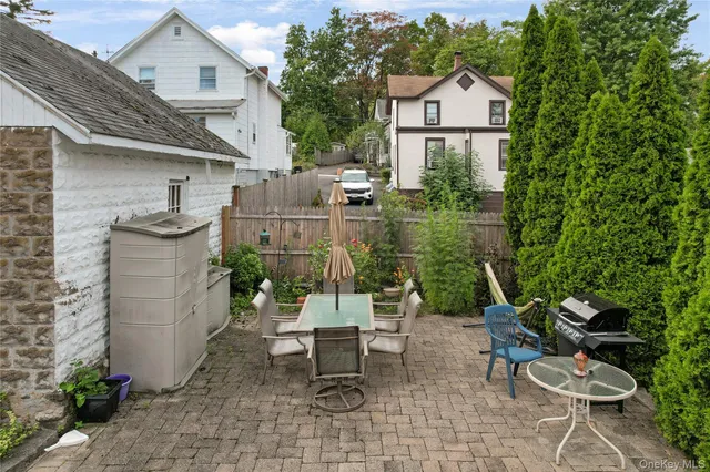 a view of a chairs and table in backyard of the house