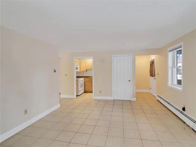 a view of an empty room with glass door