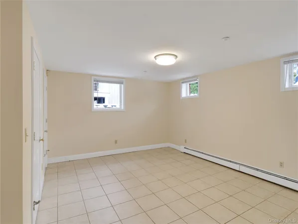an empty room with white walls and tiles