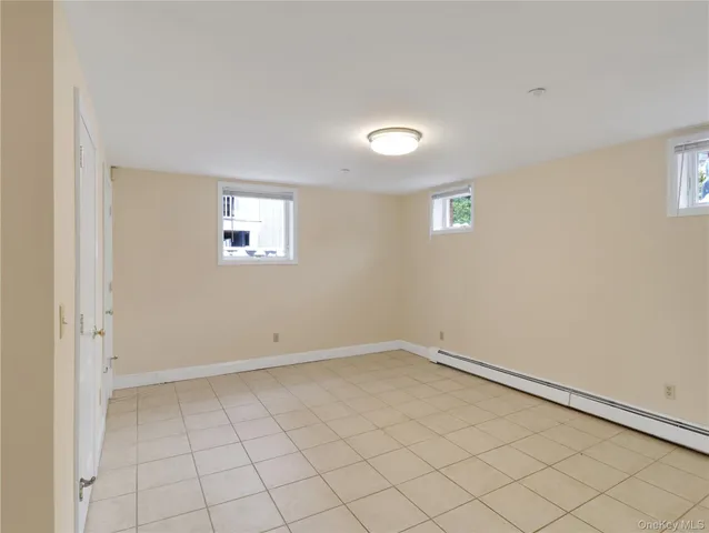 an empty room with white walls and tiles