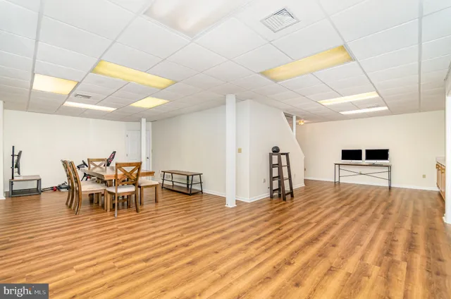 a view of a room with furniture and wooden floor