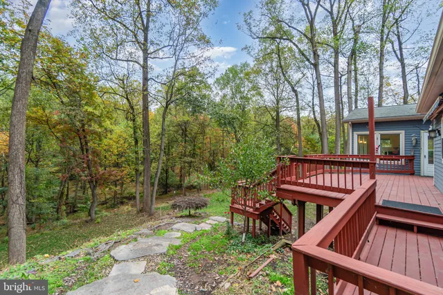 a view of backyard with deck and garden