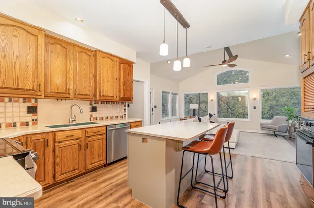 a large kitchen with a table and chairs in it