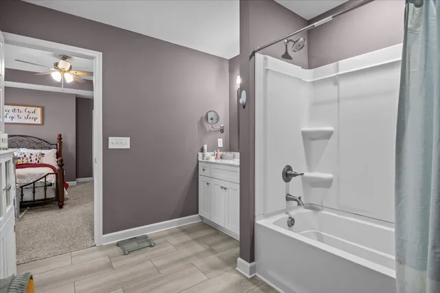 a spacious bathroom with a tub shower and sink