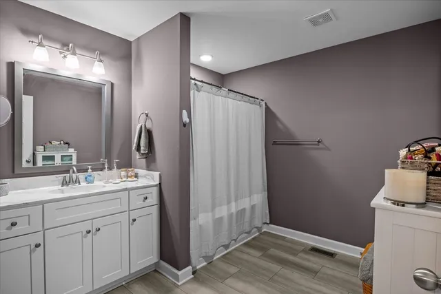 a bathroom with a double vanity sink and mirror