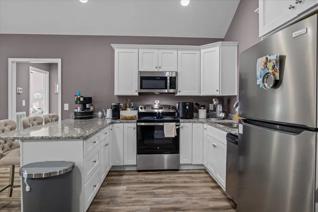 a kitchen with a refrigerator stove and sink
