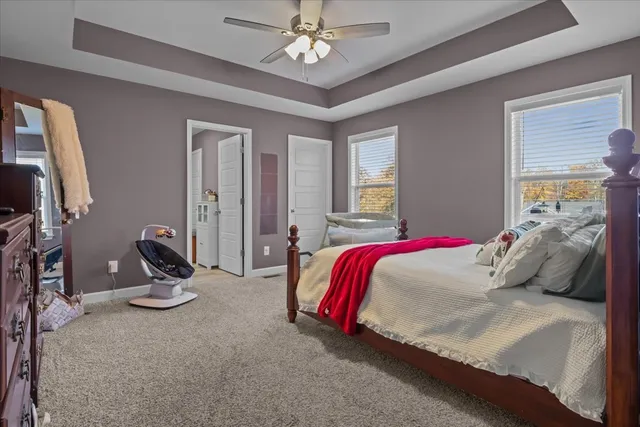 a bedroom with bed and a chandelier