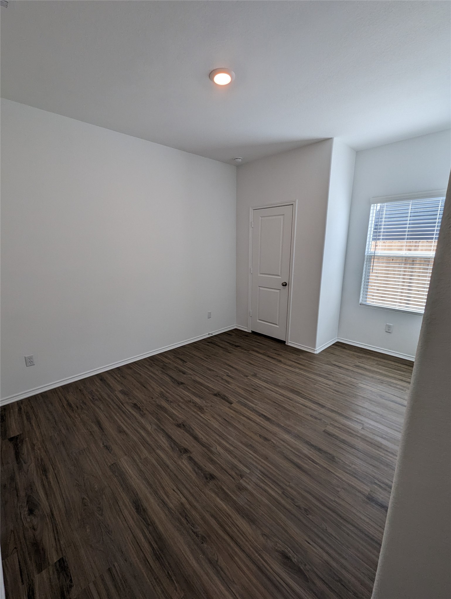 361 Soapstone Pass Maxwell, TX 78656 - Photo 16 of 17 a view of an empty room with wooden floor and a window