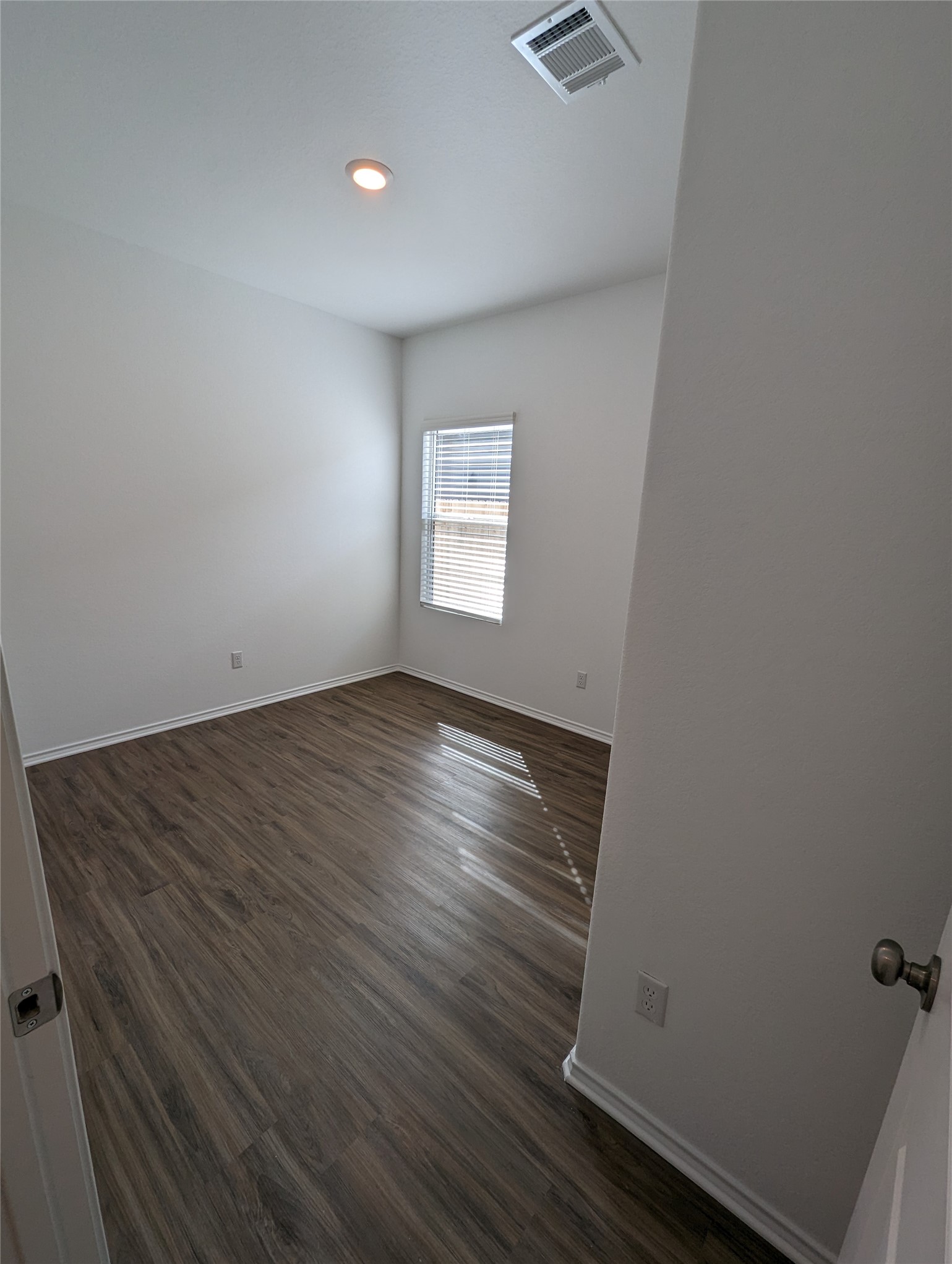 361 Soapstone Pass Maxwell, TX 78656 - Photo 17 of 17 an empty room with wooden floor and windows