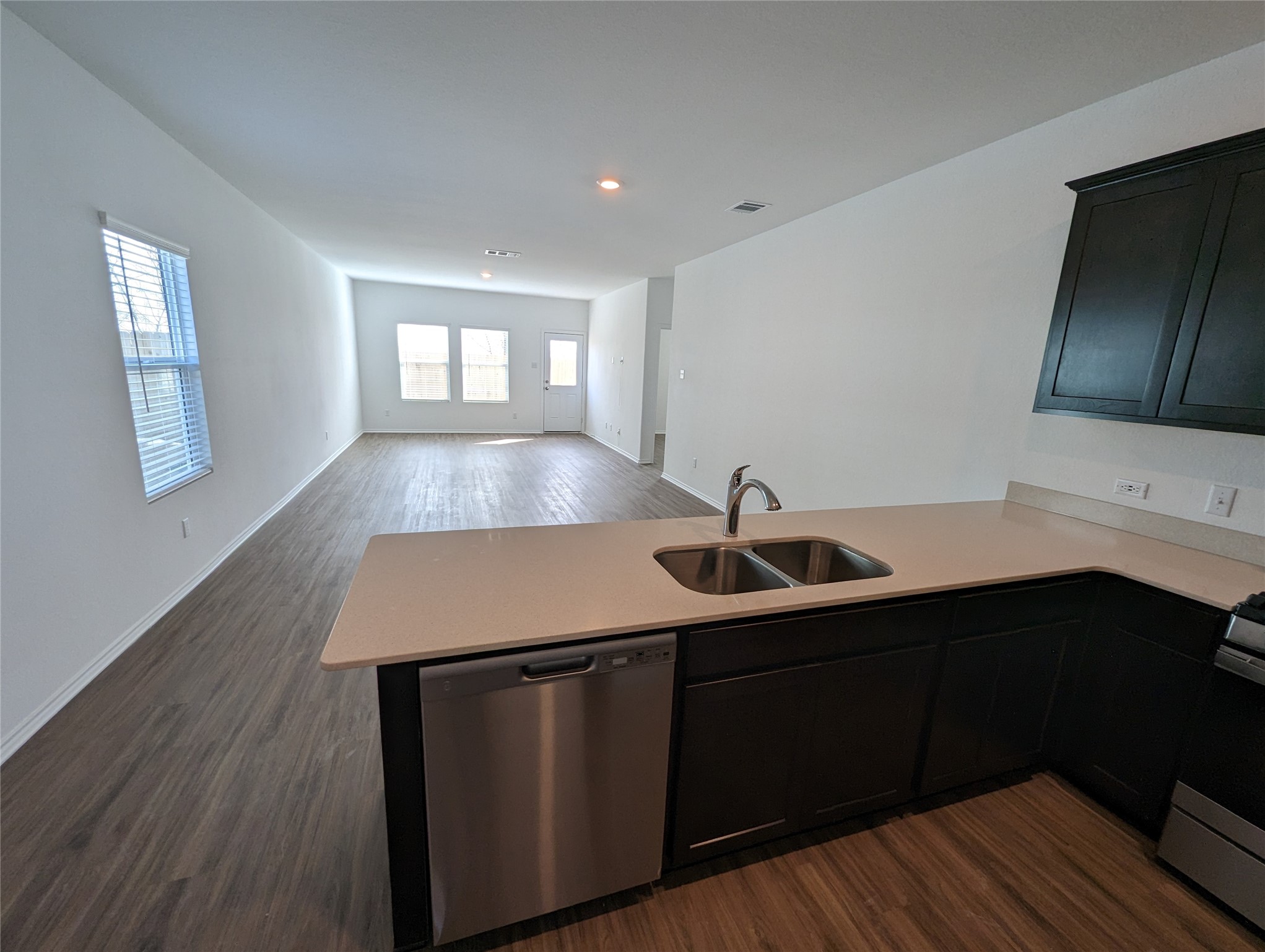 361 Soapstone Pass Maxwell, TX 78656 - Photo 6 of 17 a kitchen with a sink cabinets and wooden floor