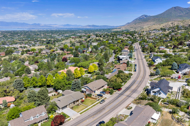 3813 North Foothill Drive Provo, UT 84604 - Photo 67 of 71 Residential neighborhood with varied architectural styles, mature trees, and a mountain backdrop