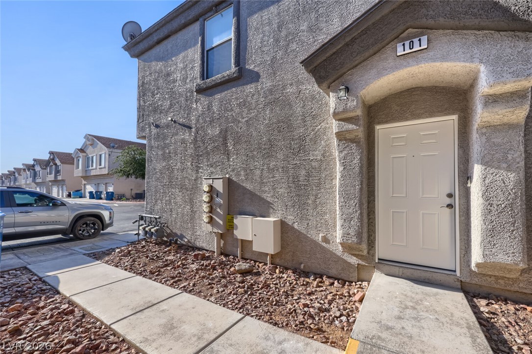 5985 High Steed Street, Unit 101 Henderson, NV 89011 - Photo 3 of 38 A welcoming entry invites residents into this modern stucco-finished property, part of a tidy neighborhood row.